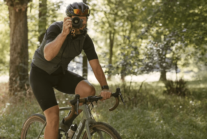 Man Cycling With Camera